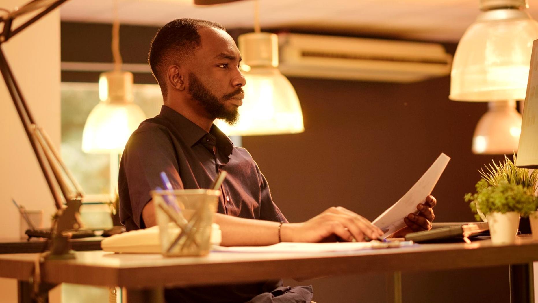 Financial analyst reviewing quarterly reports and market data